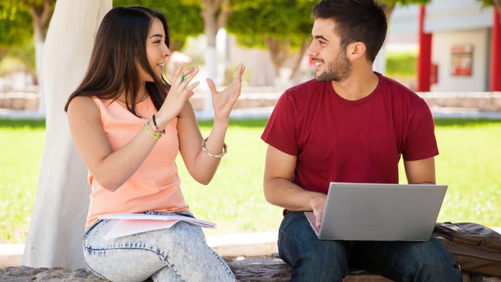 Cute girl and a friend of hers hanging out and talking about their recent school project