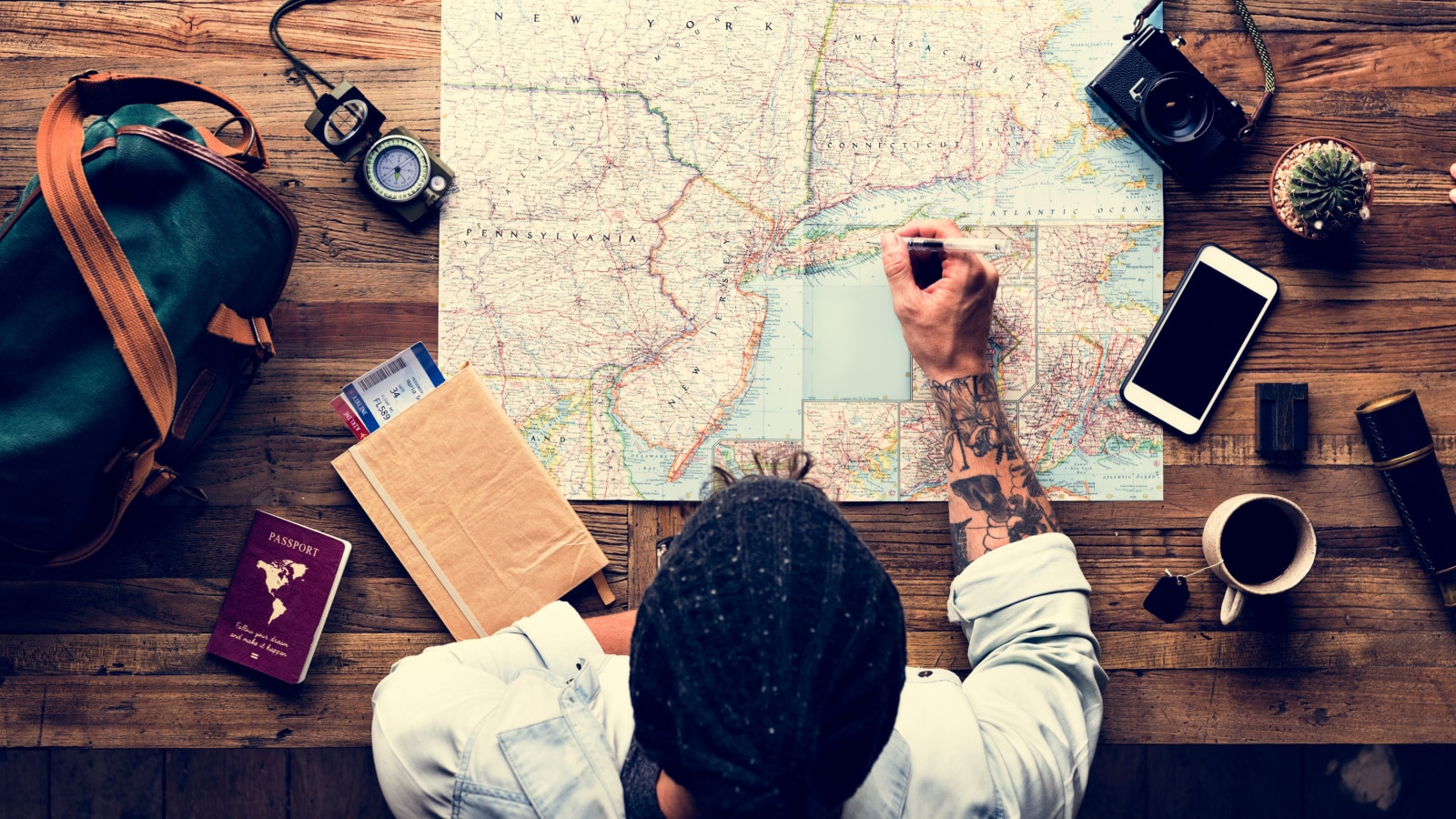 Aerial view of man planning the trip with map