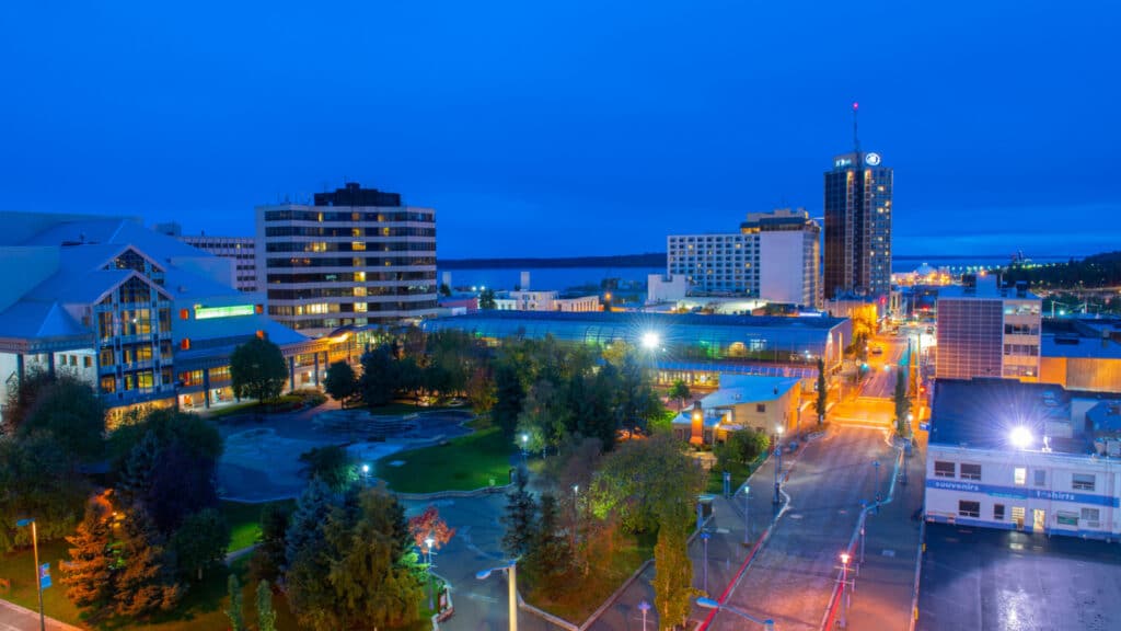 ANCHORAGE, ALASKA, USA - SEP. 21, 2019: Anchorage downtown aerial view including Alaska Center for the Performing Arts, Town Square Park and Hilton Anchorage Hotel building at night in Anchorage.