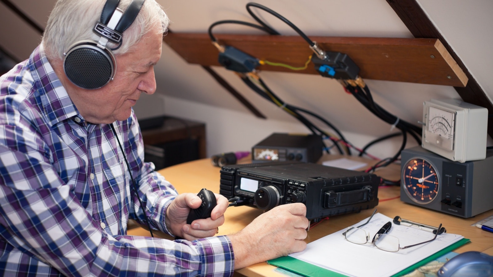 Enthusiastic middle-aged radio-amateur at his station