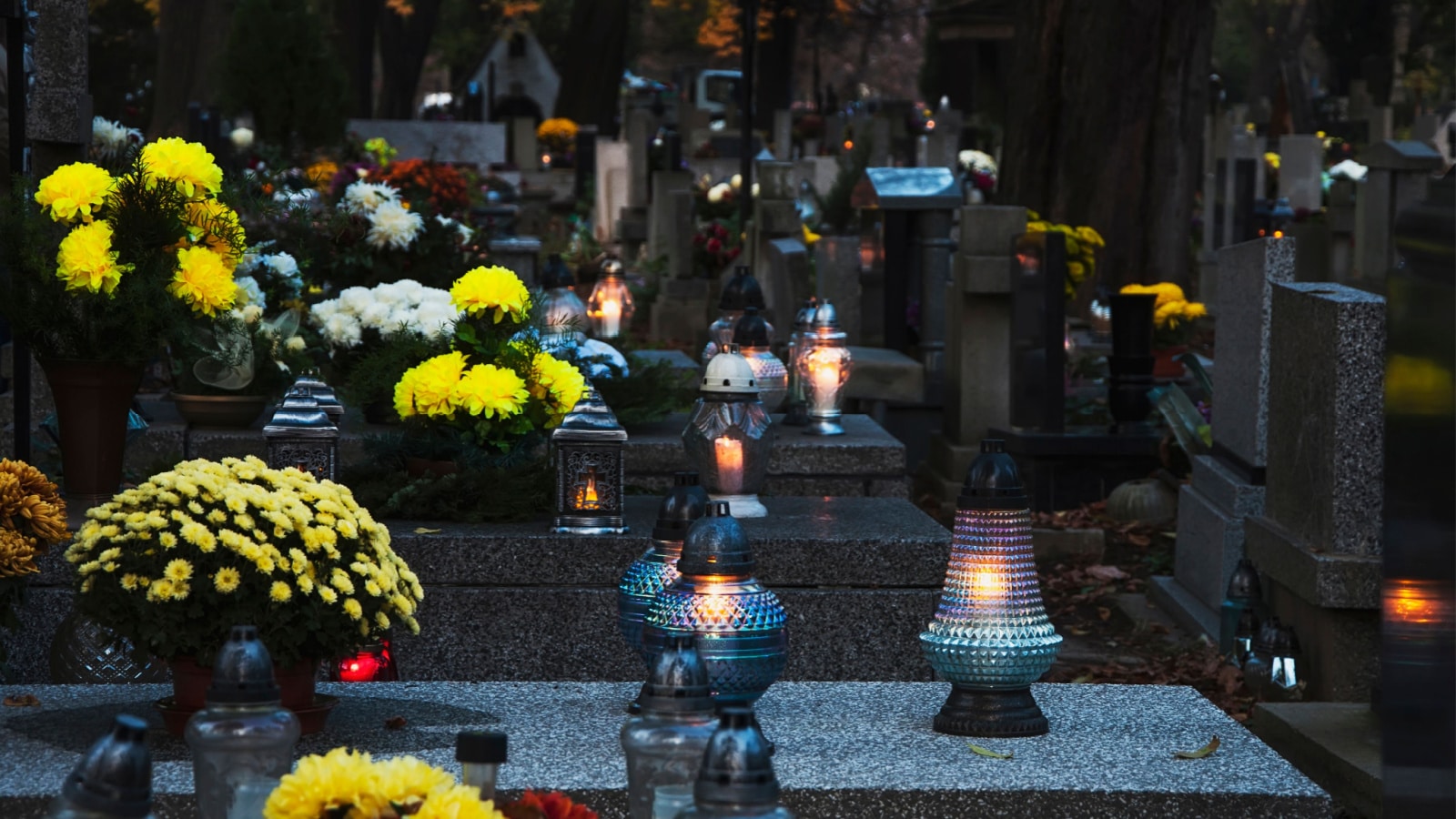 Many candles are lit, many flowers decorate the tombstones on All Saints Day