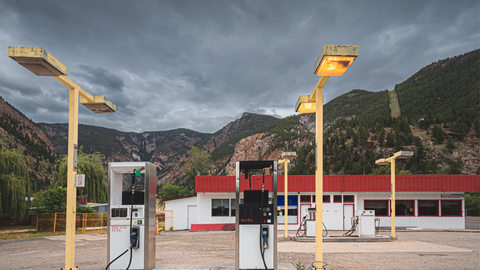 An old abandoned gas station rest stop in mining town Hedley, BC in the Okanagan against a dark moody sky.