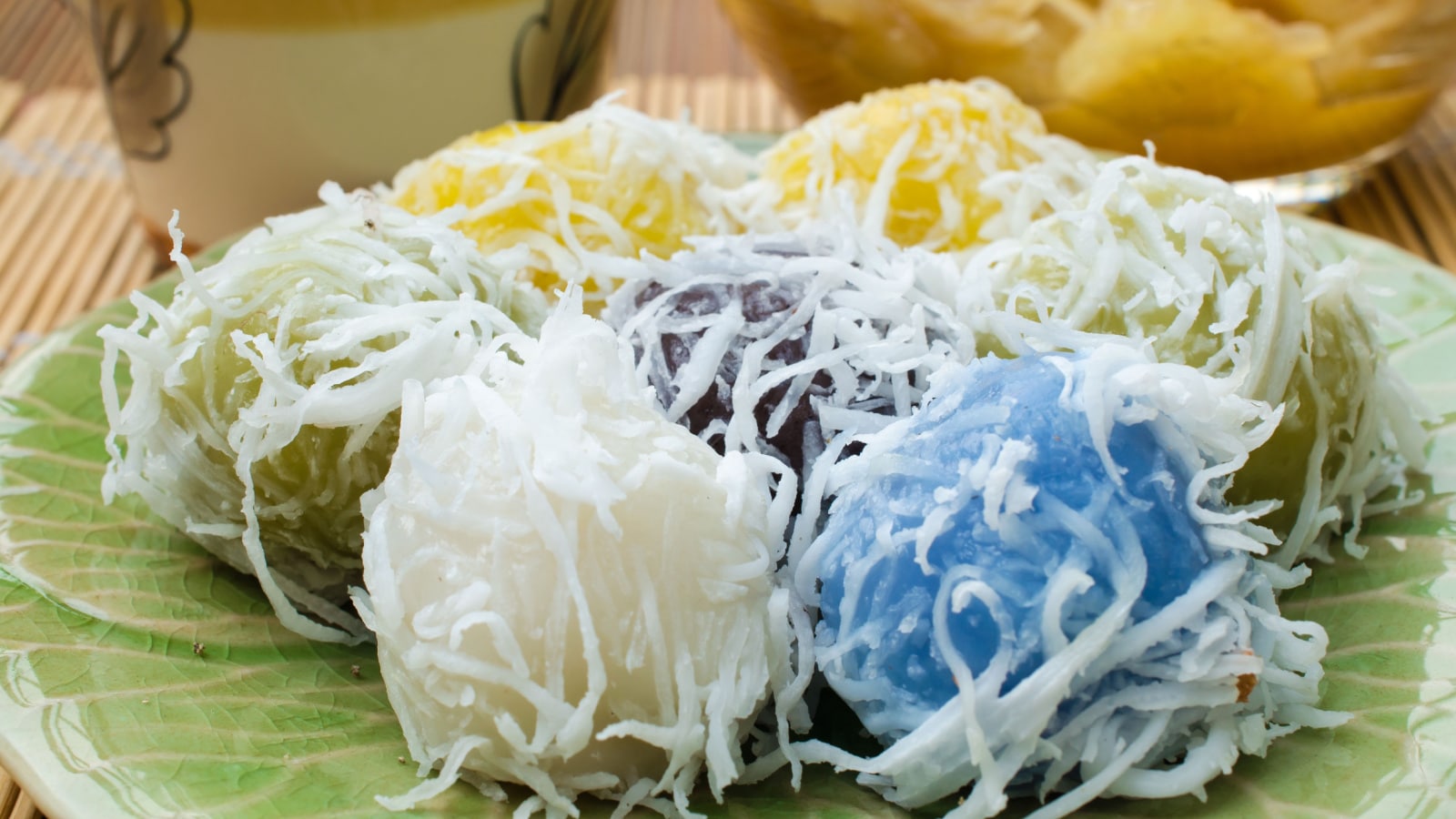 Thai dessert for rituals and eating. Flour stuffed with sweet coconut, and grated coconut topping on plate.