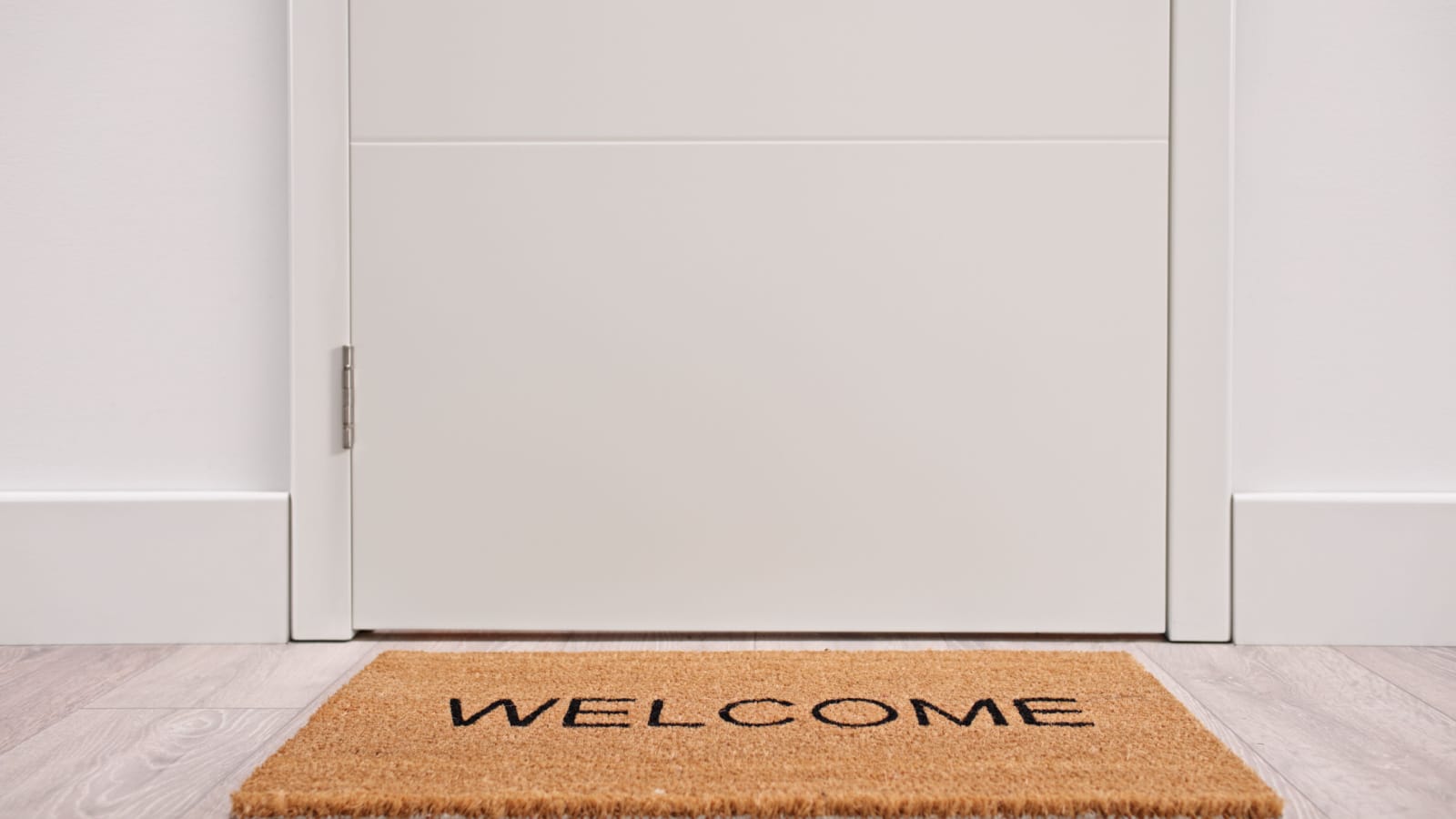 White door with a welcome mat