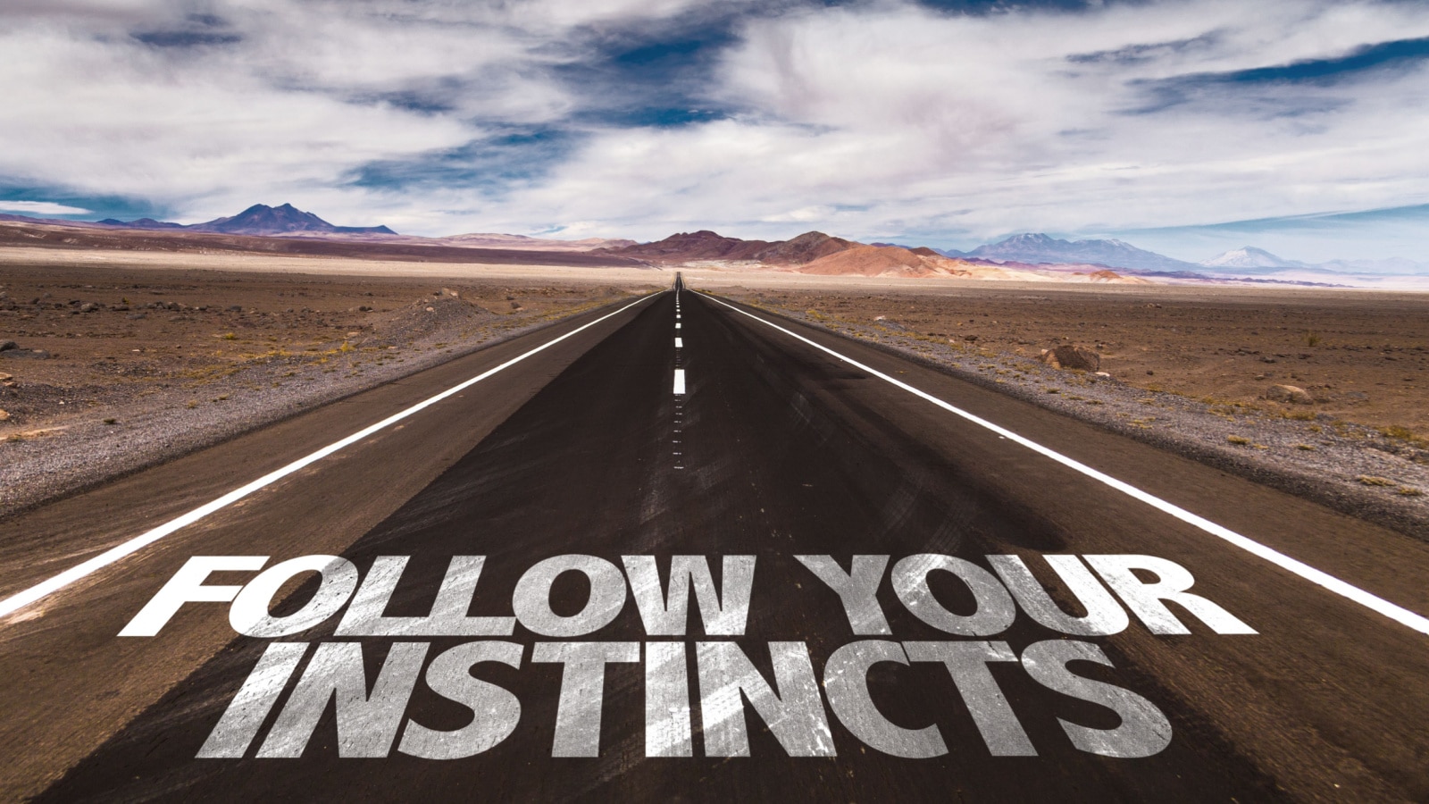 Follow Your Instincts written on desert road