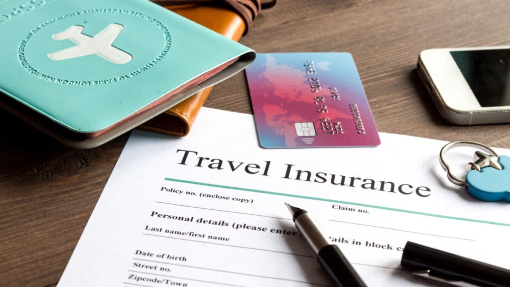 concept booking travel insurance on wooden background