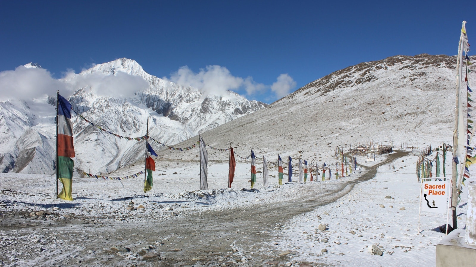 Snow mountains and Sky with Sacred flags on the path side