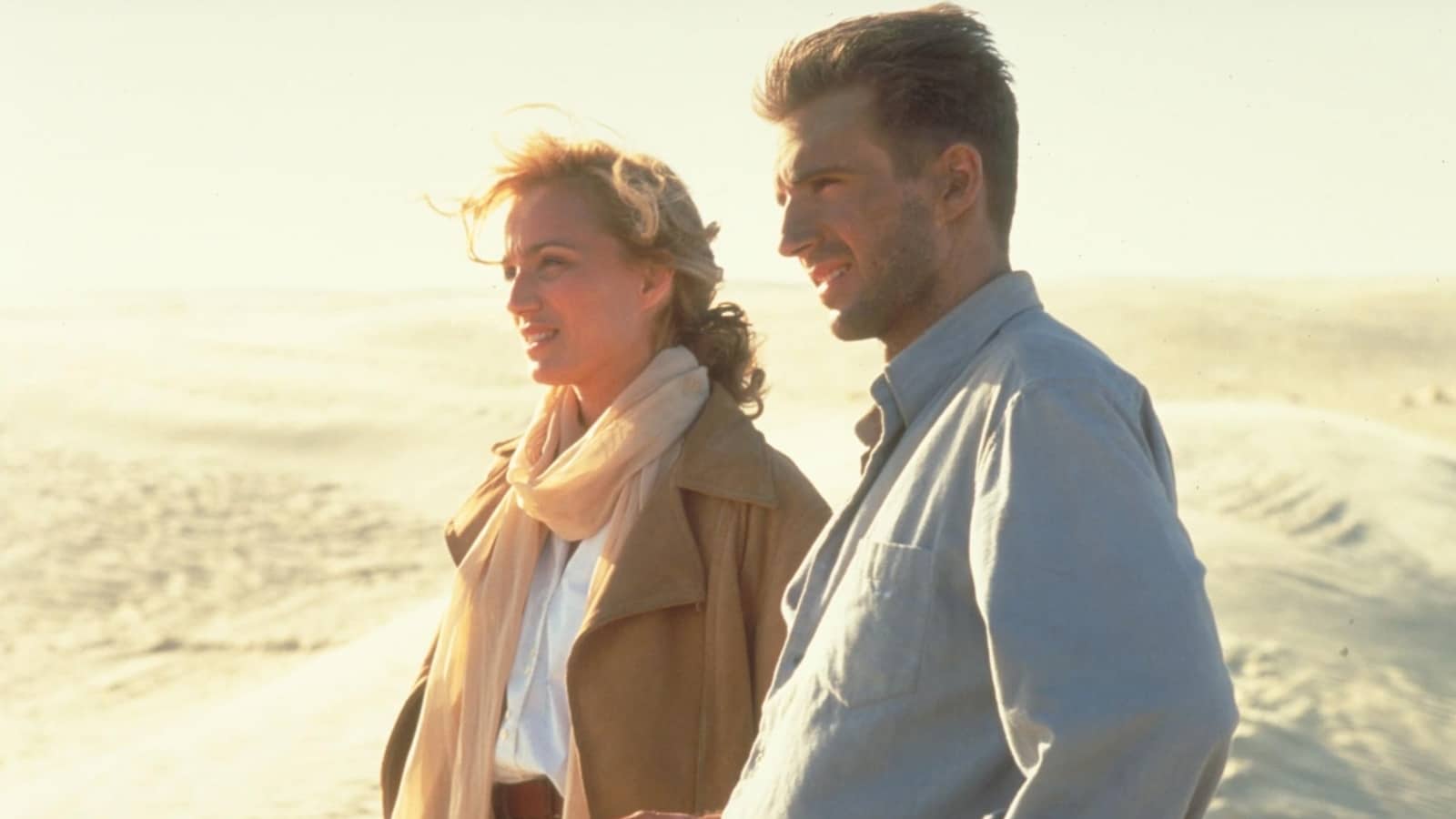 A man and woman standing together in the desert.