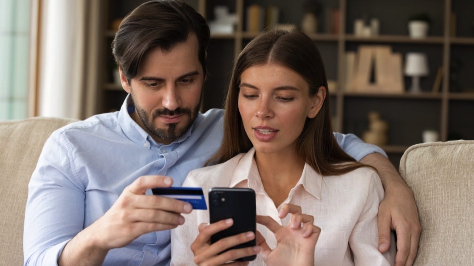 Couples using mobile for shopping