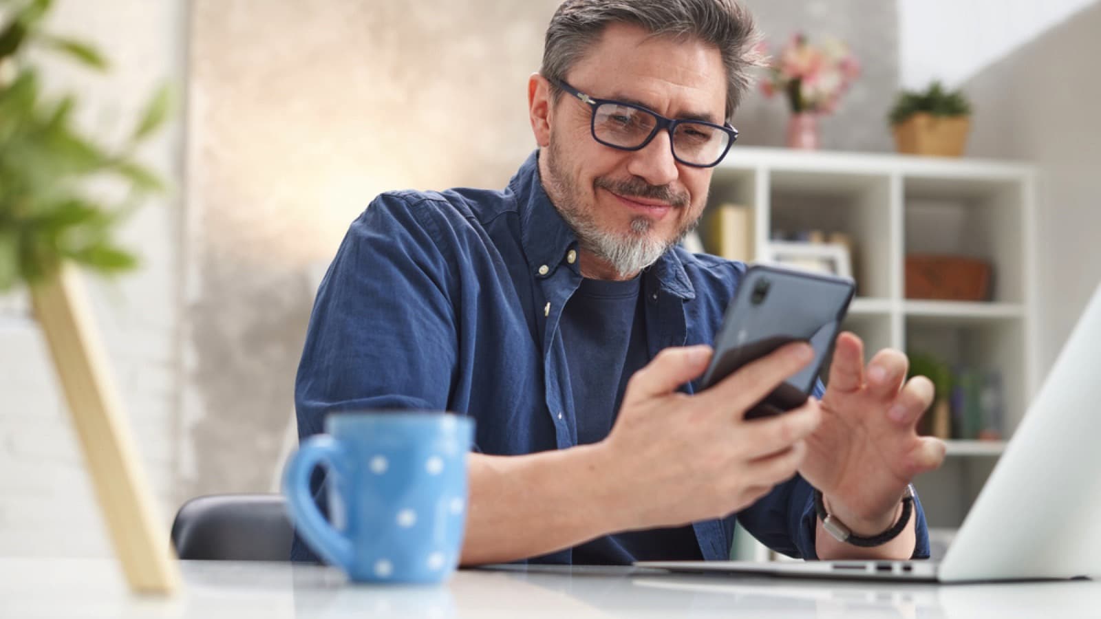 Man using mobile having coffee