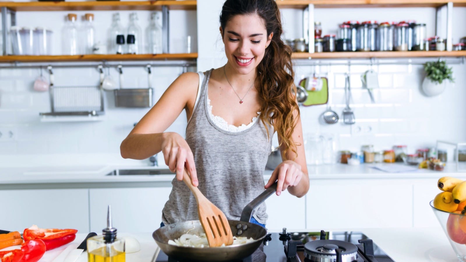 Young woman cooking in kitchen