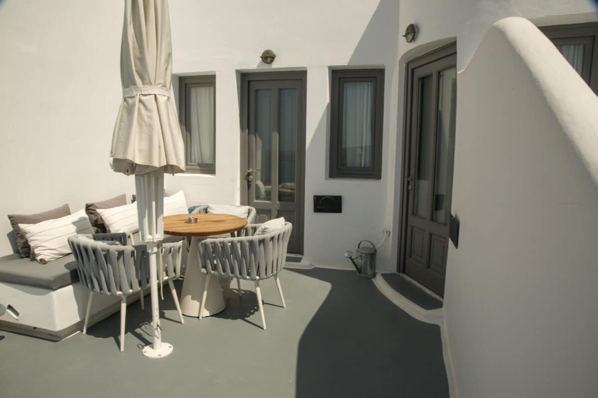 A patio area set against a white building in Santorini