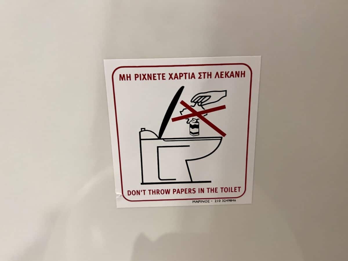 Don't flush toilet paper sign in the bathroom in Santorini.