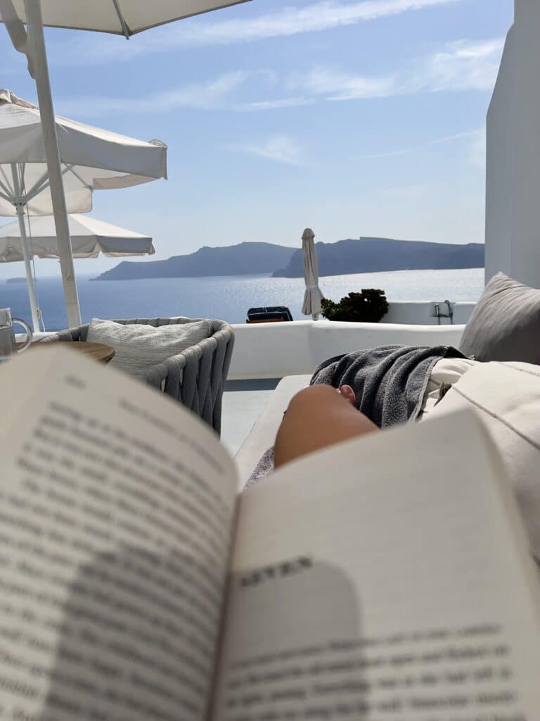 Me, reading a book from our patio area at the IKIES Santorini.