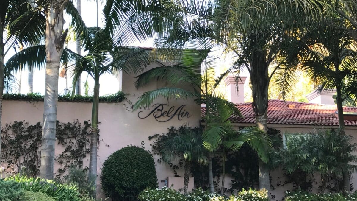 LOS ANGELES, Dec 11, 2019: Hotel Bel-Air exterior wall and logo surrounded by palms. The famous 5-star hotel has housed many celebrity guests and is owned by the family of the Sultan of Brunei.