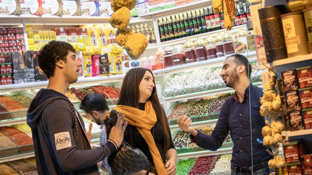 Istanbul, Turkey October 2019 A man and a woman trying to haggle with a salesman in the Istanbuls grand bazaar. World's biggest marketplace.