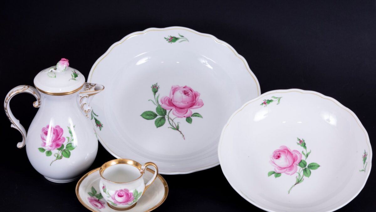 Porcelain set with floral pattern, home kitchenware objects made of composition on black background, antique porcelain set buying now.