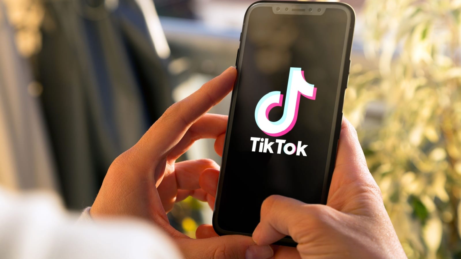 Tiktok on mobile phone Screen. Young woman holding a Smart Phone with Tik Tok app. ROSARIO, ARGENTINA -MARCH 15, 2023.