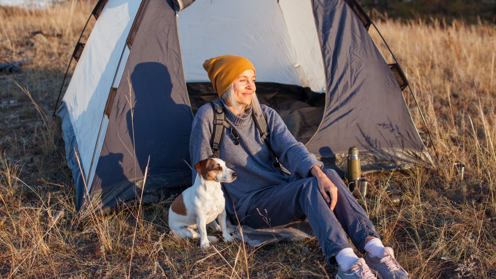 Middle aged woman travel and camping alone at fall forest. Recreation and journey outdoor activity lifestyle