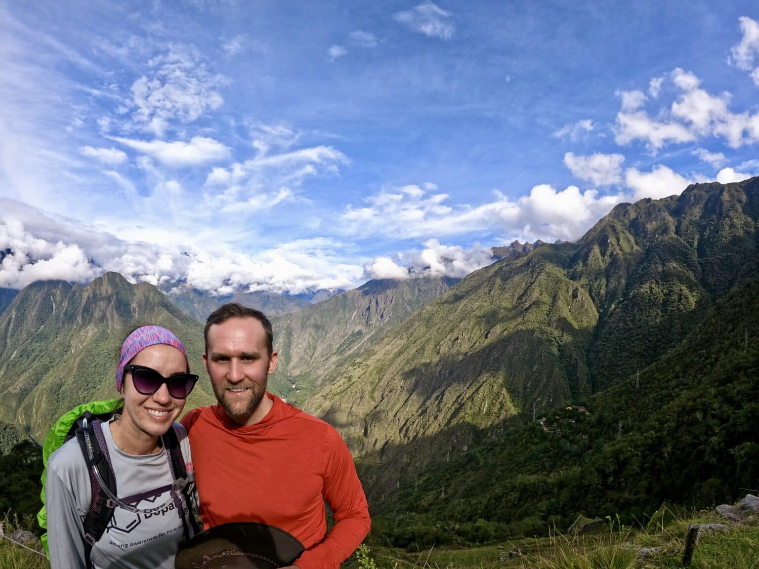 The Inca Trail view of the lush forest landscape with two smiling hikers