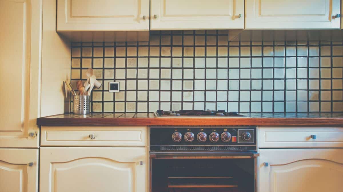 Vintage retro kitchen with green pattern tiles, american retro kitchen home interior design 70's 80's style close-up. retro background