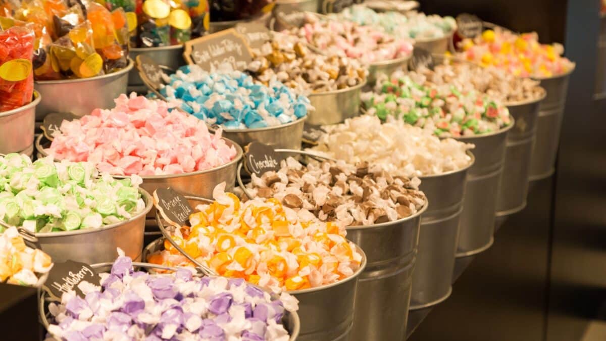 Buckets filled with taffy candy at a candy shop.