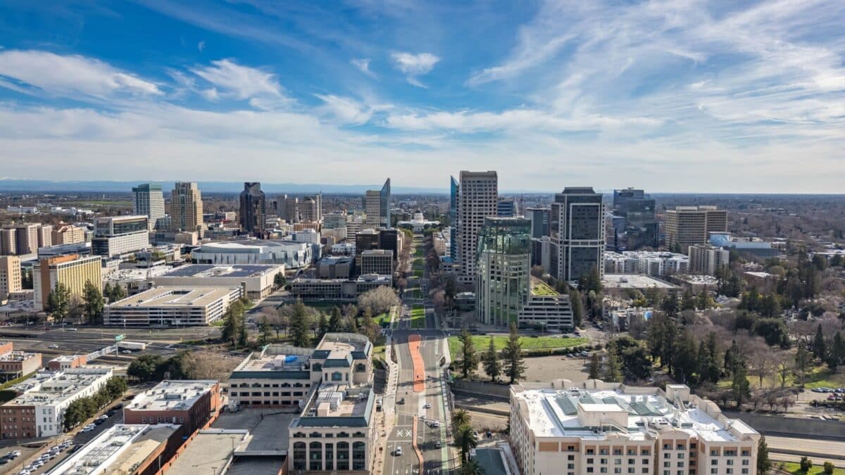 An aerial image of the Tower Bridge and State Capitol Building in Sacramento, California on a beautiful day after a rain storm that filled the Sacramento River.