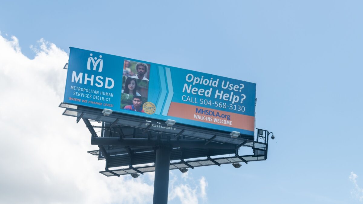 New Orleans, USA - April 22, 2018: Highway road with view of billboard commercial sign for MHSD opioid epidemic help hotline human services clinic