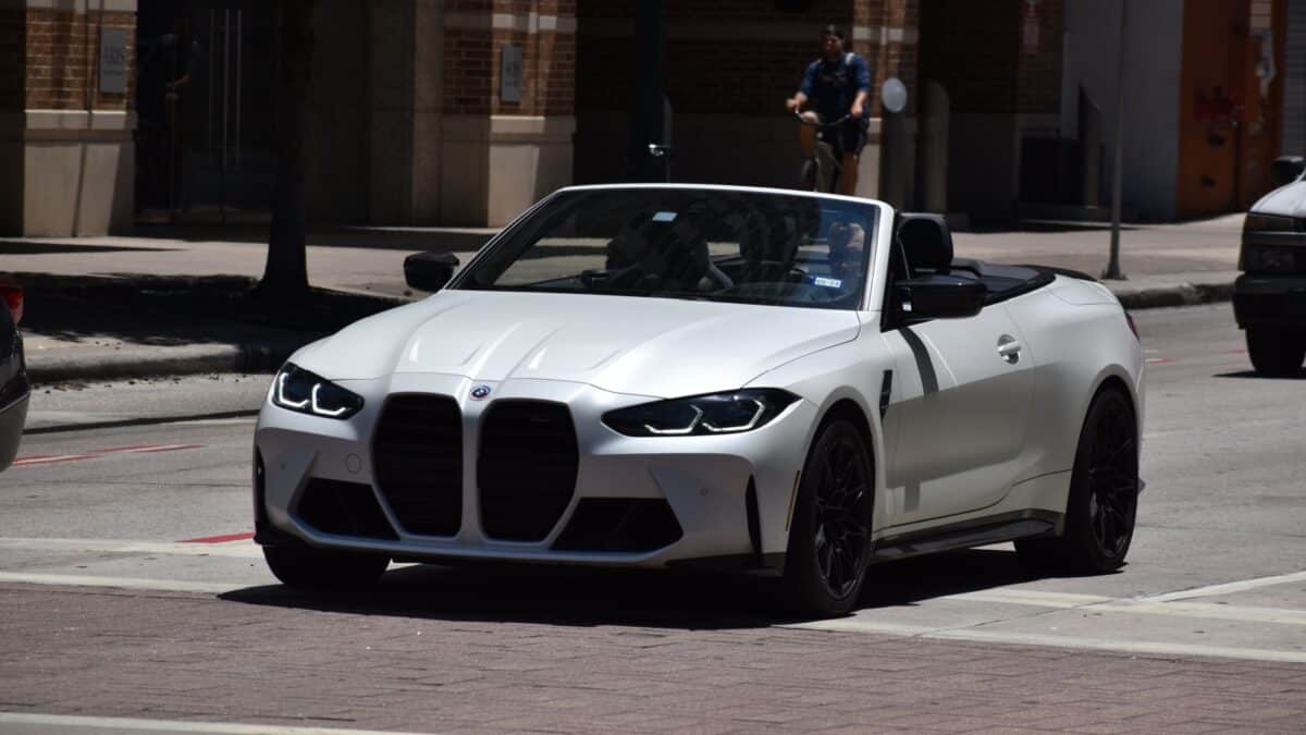 Houston, TX USA - 5-15-2024 - A portrait of a BMW M4 Convertible Sports car cruising in a downtown financial district.